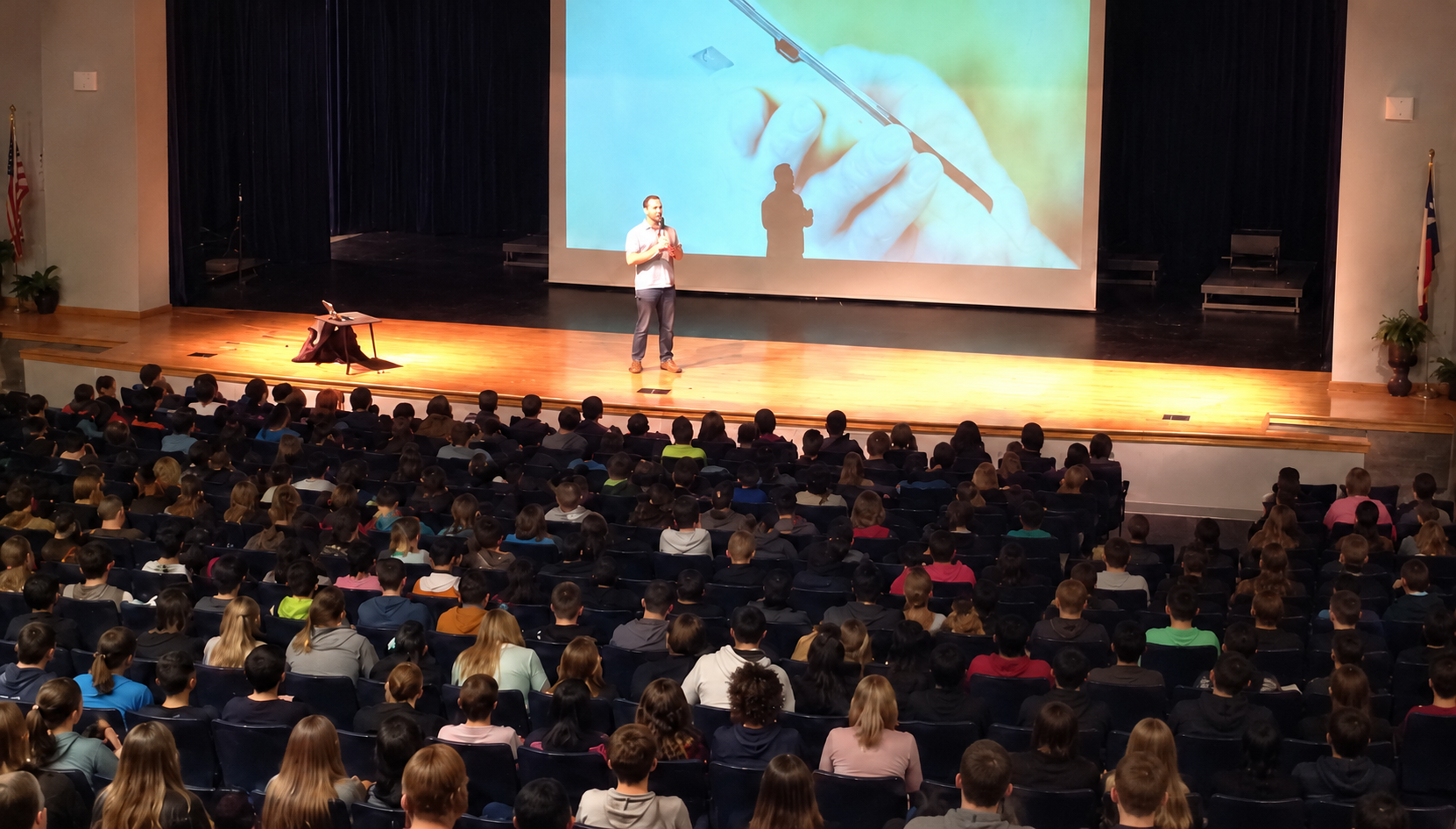 Jonathan McKee speaking to a full auditorium.