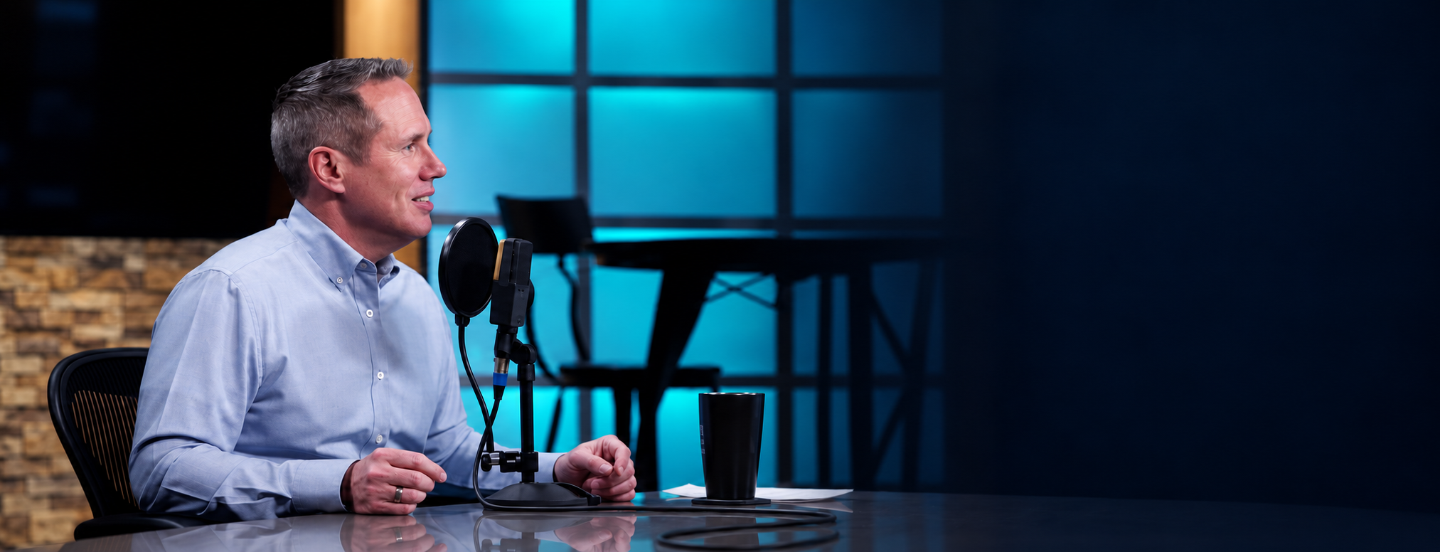 Jonathan McKee in conversation at a studio microphone.